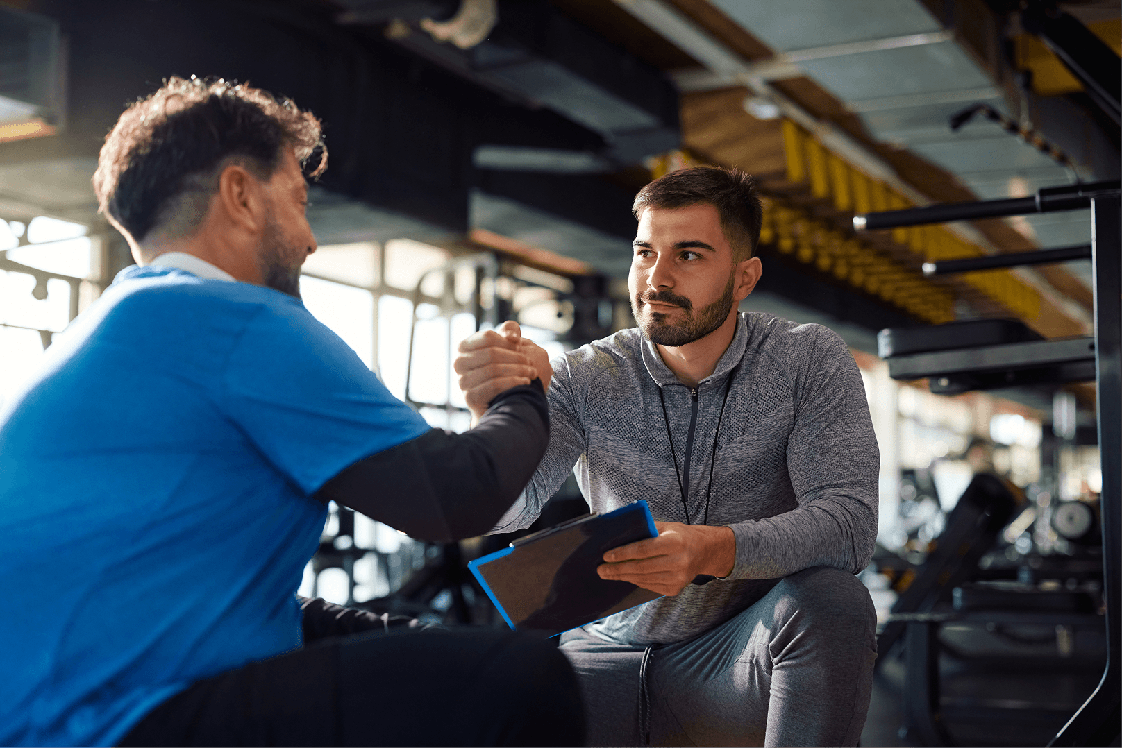 A coach managing client programs on a tablet