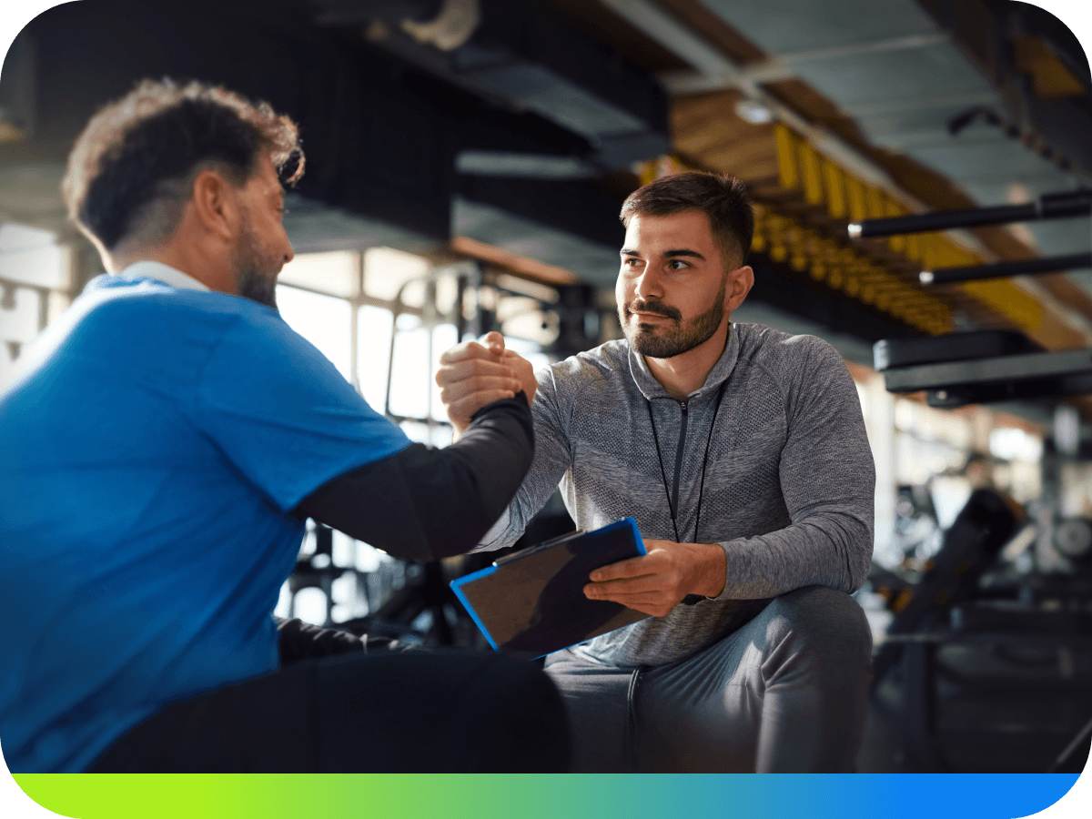 A coach managing client programs on a tablet